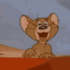 jerry from tom and jerry is laughing and pointing at the camera .