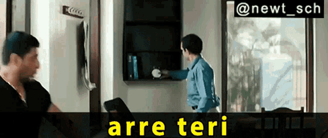 a man standing next to another man in a room with the words arre teri on the bottom